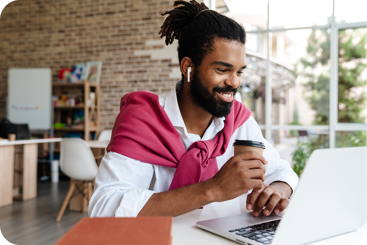 smiling-african-american-guy-drinking-coffee-while-2025-02-16-05-36-00-utc 1