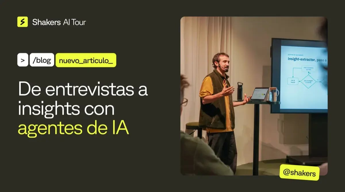 Cartel del taller con dos mitades: a la izquierda, el titular 'De entrevistas a insights con agentes de IA' en tipografía blanca y lima sobre fondo verde oscuro, con el logo de Shakers y etiquetas de terminal; a la derecha, fotografía del ponente con chaleco verde presentando ante el público, con una pantalla que muestra el diagrama del insight extractor