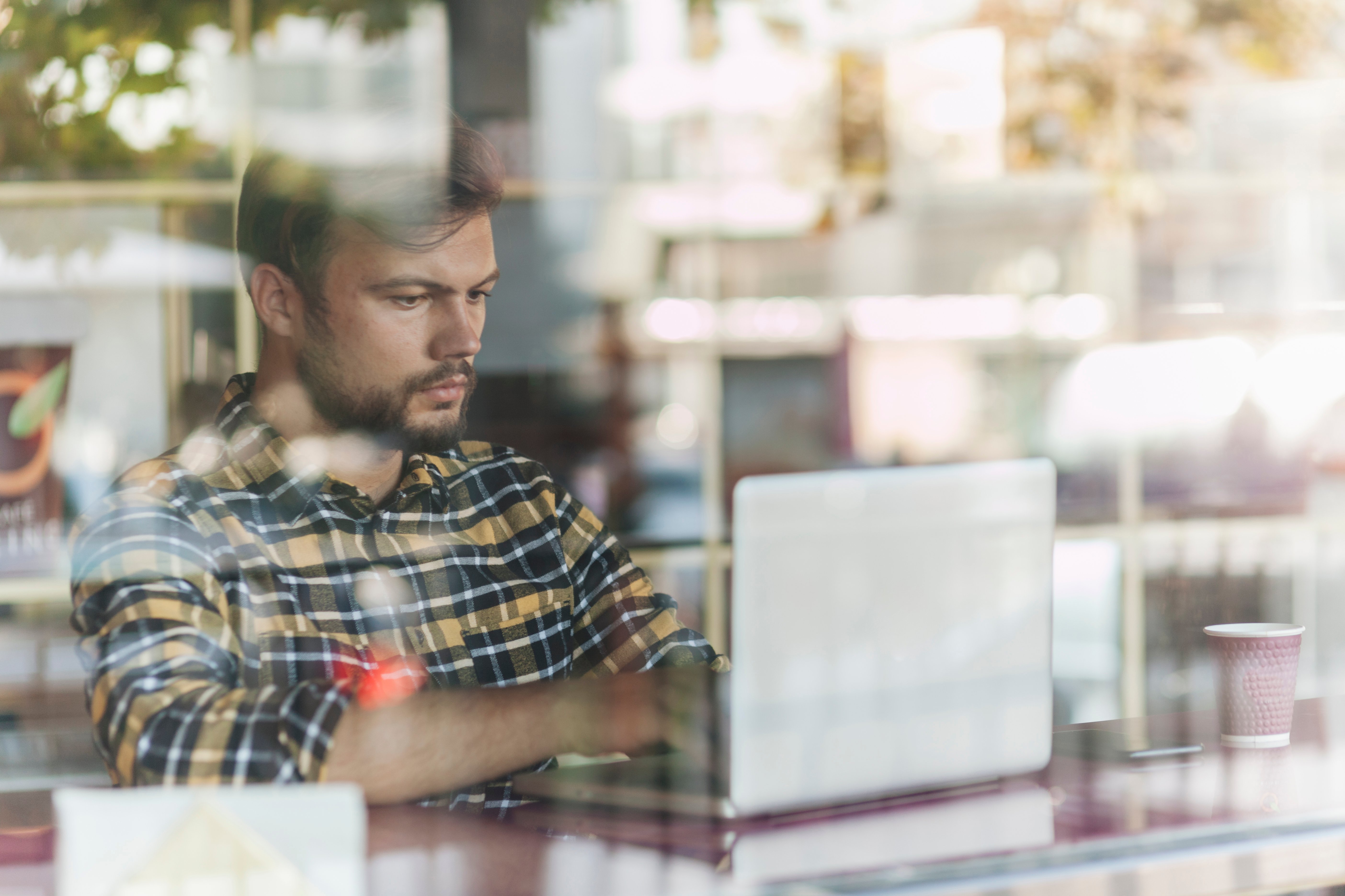 man-using-laptop-coffee-shop