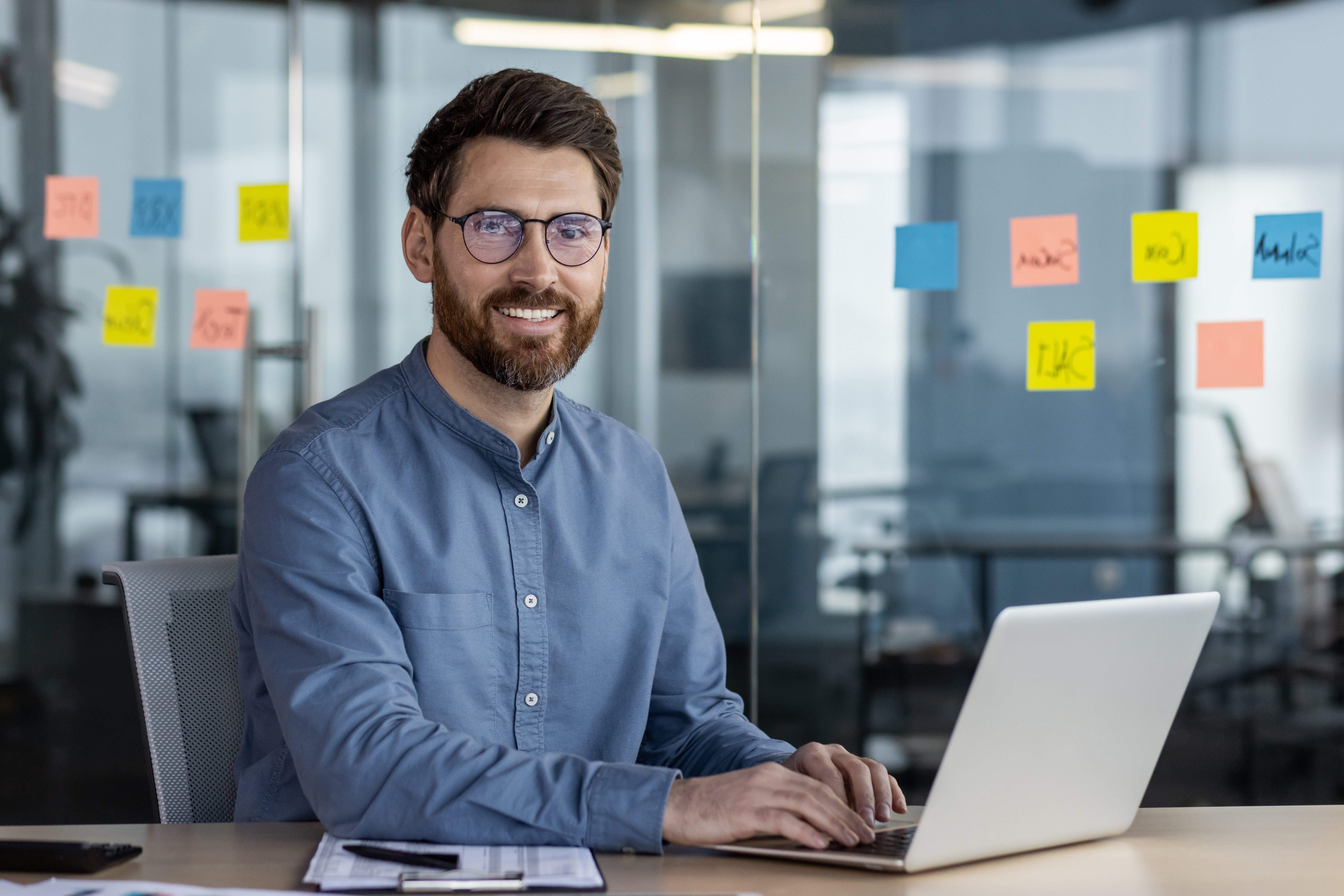 portrait-of-a-smiling-young-businessman-sitting-in-2024-08-22-21-33-38-utc